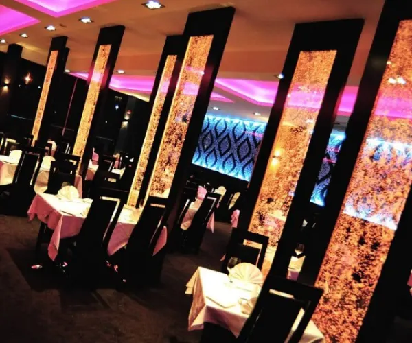 Red-lit bubble panels lining a lounge corridor