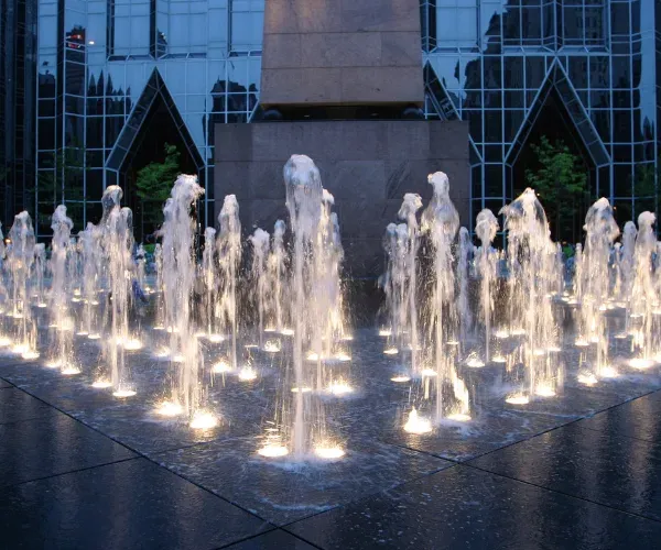 Burst of clear crystal jets from a plaza fountain floor
