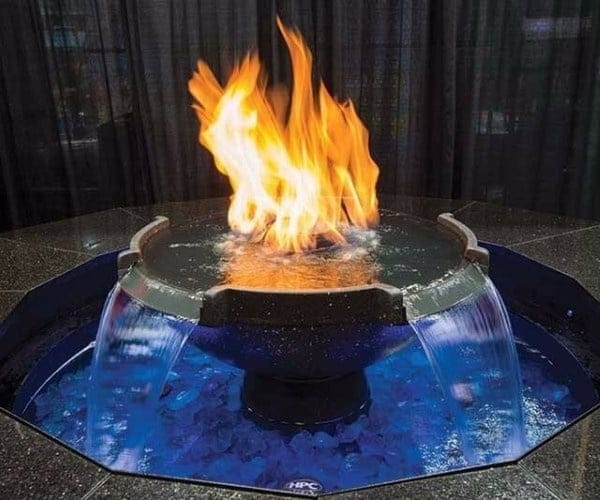 Ring of gas flame floating over a blue-lit water bowl