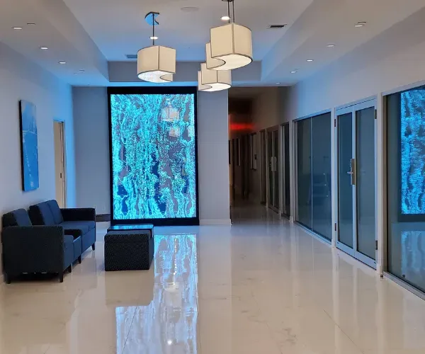 Two blue-lit bubble panels flanking a lobby seating area