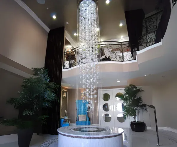 Crystal rain column falling through a planted atrium