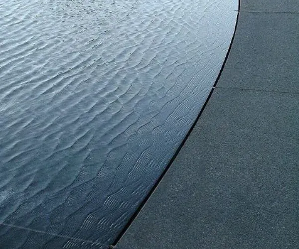 Infinity edge of a still reflection pool meeting the horizon