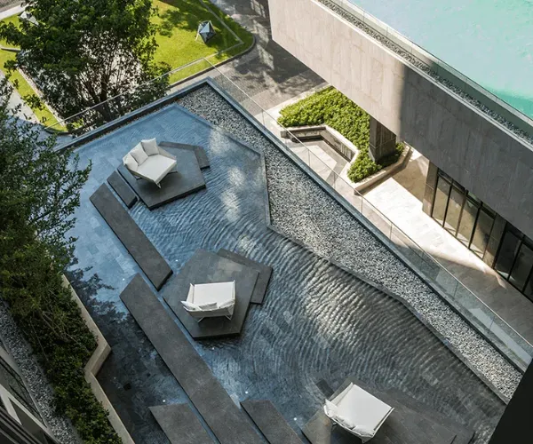 Aerial of a courtyard seating island set within a reflection pool