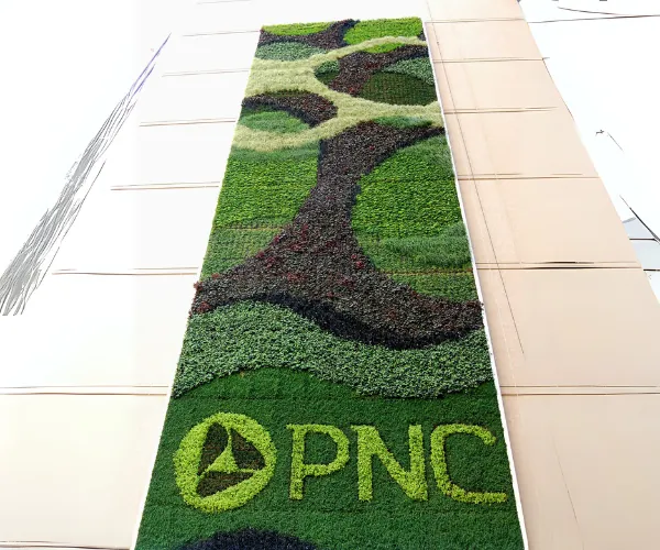 PNC logo planted into a tall patterned living facade wall