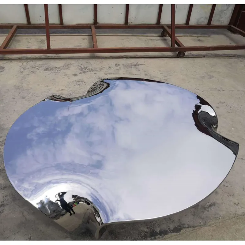 Mirror-polished stainless table with a flowing edge