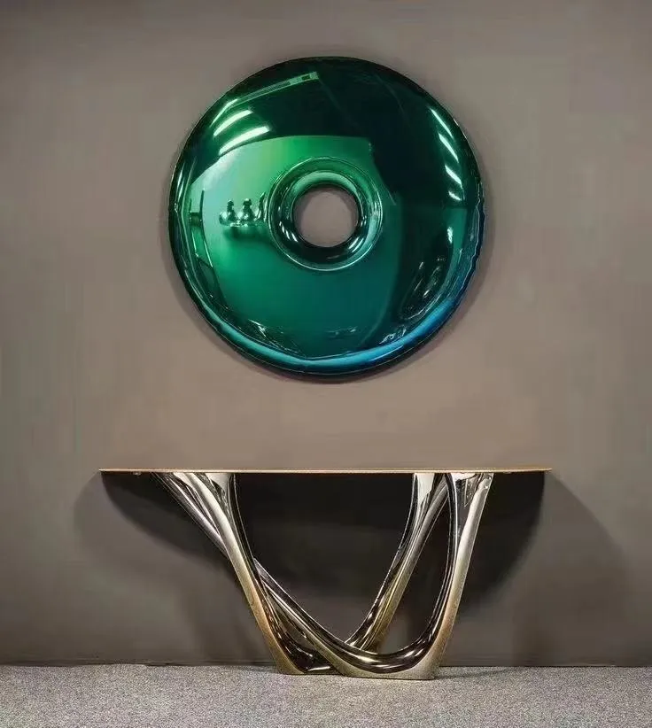 Teal glass disc wall piece with a chrome center