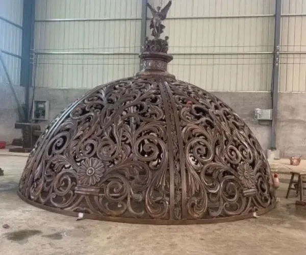 A monumental filigree metal dome under fabrication in the Element Designs shop