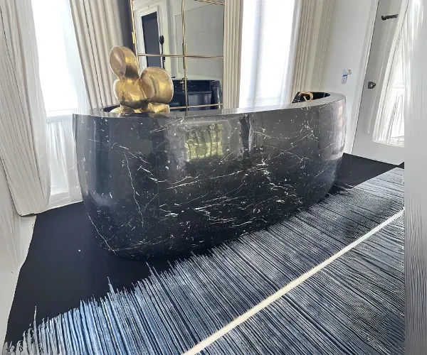 Black marble reception desk with gilded accents in a residence