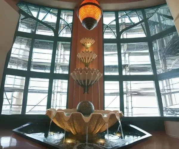 Carved shell fountain set into an ornate interior bay window