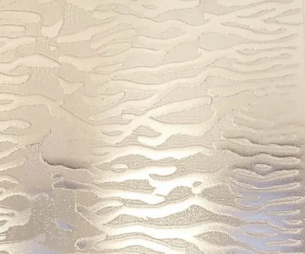 Warm champagne-toned water ripple over wire mesh